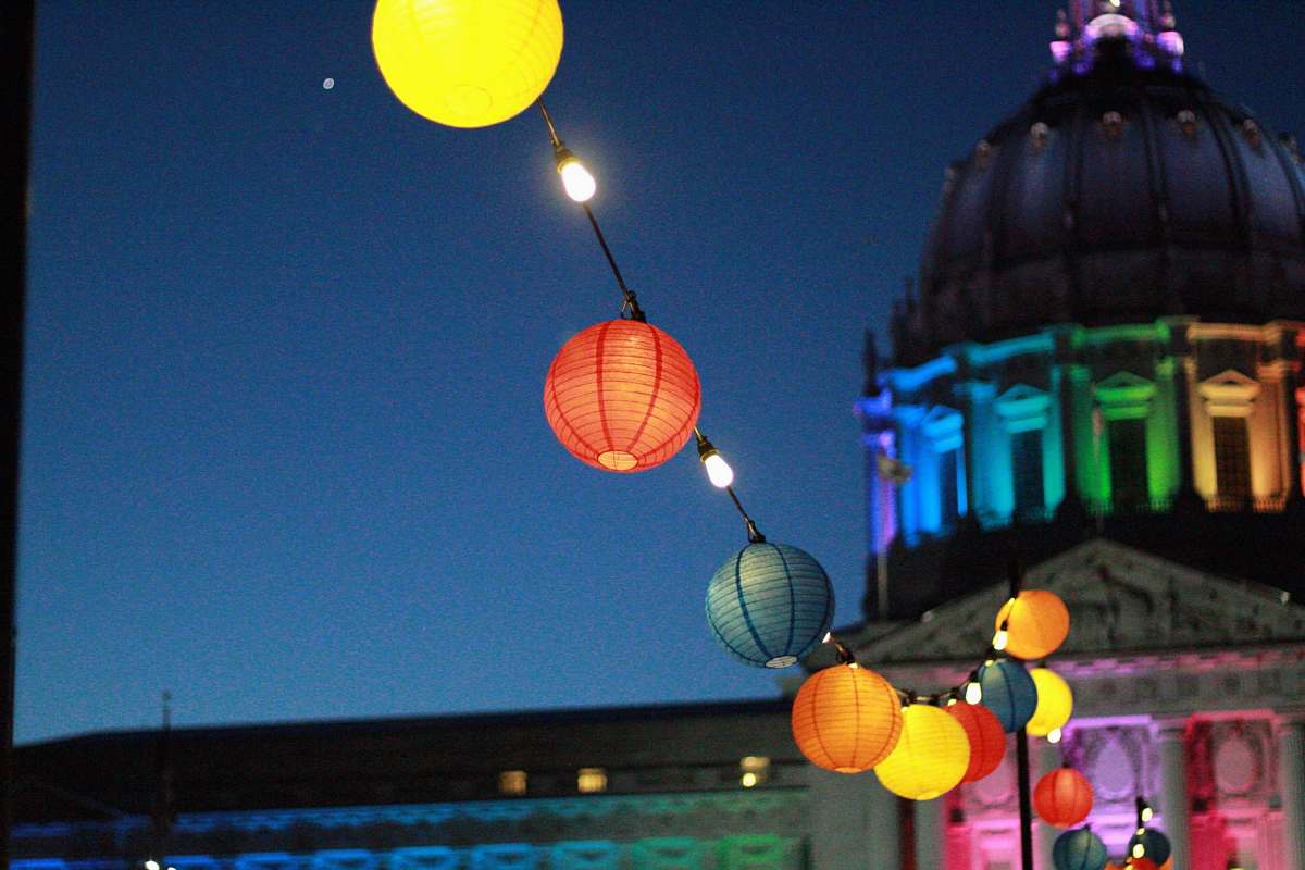 san francisco line of lighted lanterns in front of dome building during nighttime ball